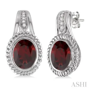 9x7 MM Oval Cut Garnet and 1/20 Ctw Single Cut Diamond Earrings in Sterling Silver